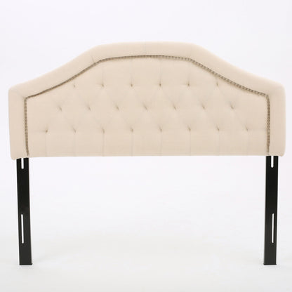 The Queen & Full Size Headboard With Diamond Tufting And Nailhead Trim in beige features a tufted diamond pattern, decorative nailhead trim, and is supported by two black metal legs, shown against a plain white background.