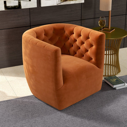 The Delaney Ergonomic Design Swivel Chair in vibrant orange velvet with a tufted backrest sits on a gray rug beside a round gold side table holding a wine glass and book in a contemporary living space.
