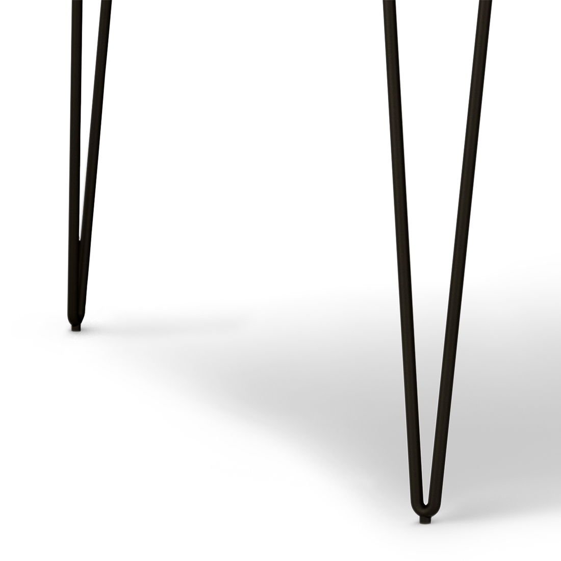 Close-up of two black metal hairpin legs from the Hunter - Square Tabletop Dining Table on a white background. The thin, angled legs cast soft shadows on the surface.