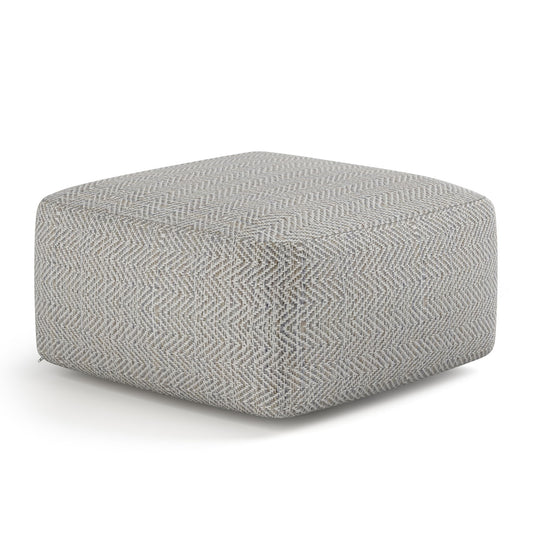 The Nate - Handcrafted Square Pouf is a modern square ottoman with light gray and white herringbone fabric, featuring soft cushioning, smooth edges, and shown on a plain white background.