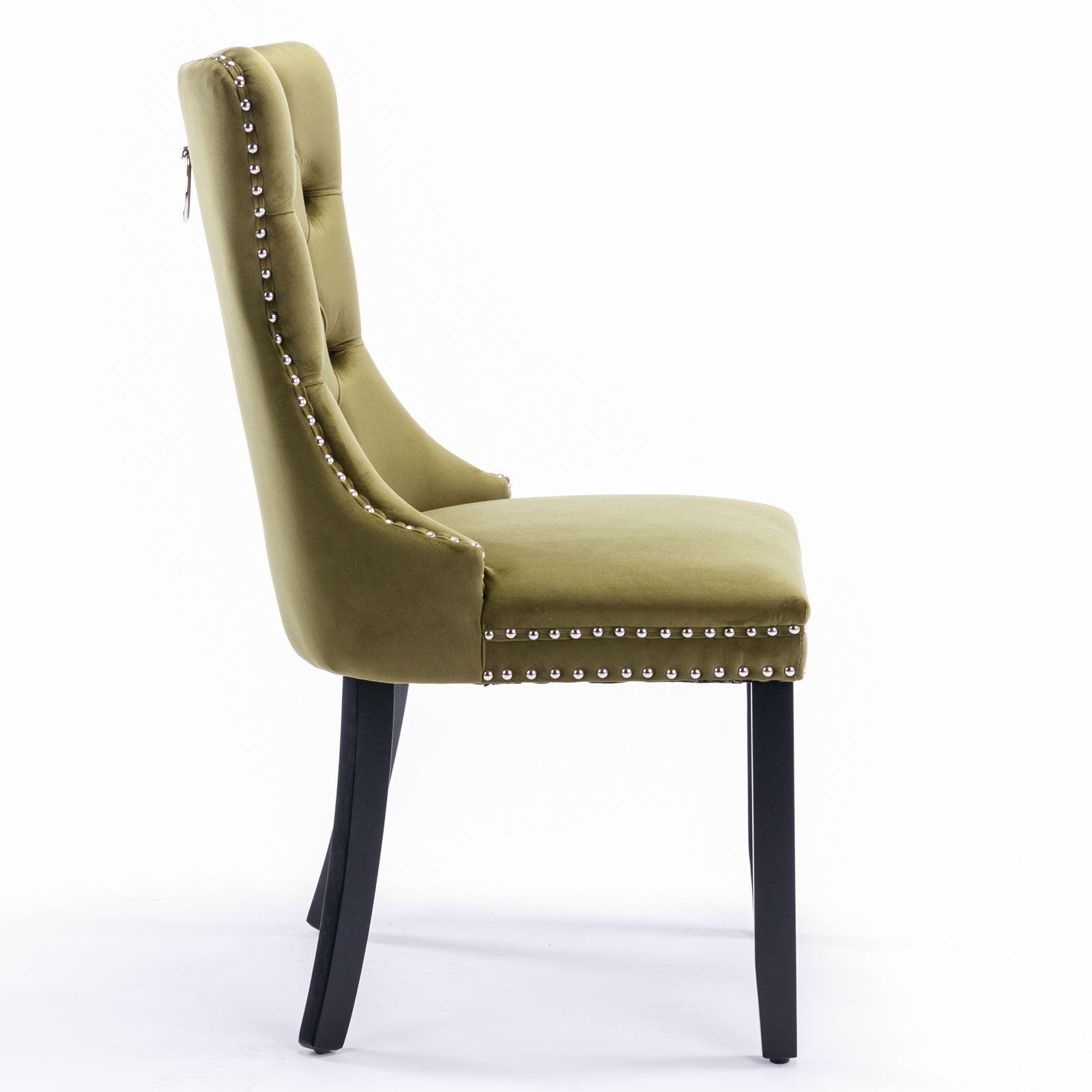 A side view of the Nikki modern velvet dining chair (set of 2) featuring green upholstery, tufted backrest with a metal ring, silver nailhead trim along the edges, and sturdy black wooden legs.