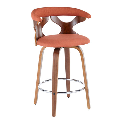 The Gardenia - Mid Century Modern Fixed Height Counter Stool With Swivel (Set of 2) features a curved wooden backrest with open cutouts, an orange cushioned seat, angled wooden legs, and a circular chrome footrest for a contemporary look.