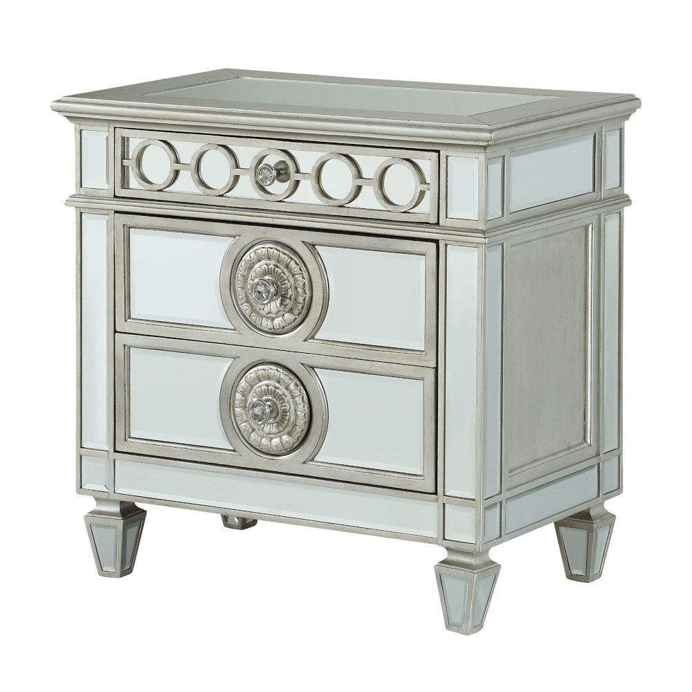 The Varian Mirrored Nightstand in Silver features two drawers, elegant circular accents, silver trim, and tapered legs for a glamorous look.