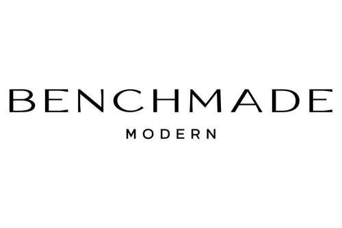 The image displays the logo of "Benchmade Modern," featuring the company name in a clean, sans-serif font. "BENCHMADE" is written in larger letters, while "MODERN" is written below it in smaller letters, all in black against a white background.
