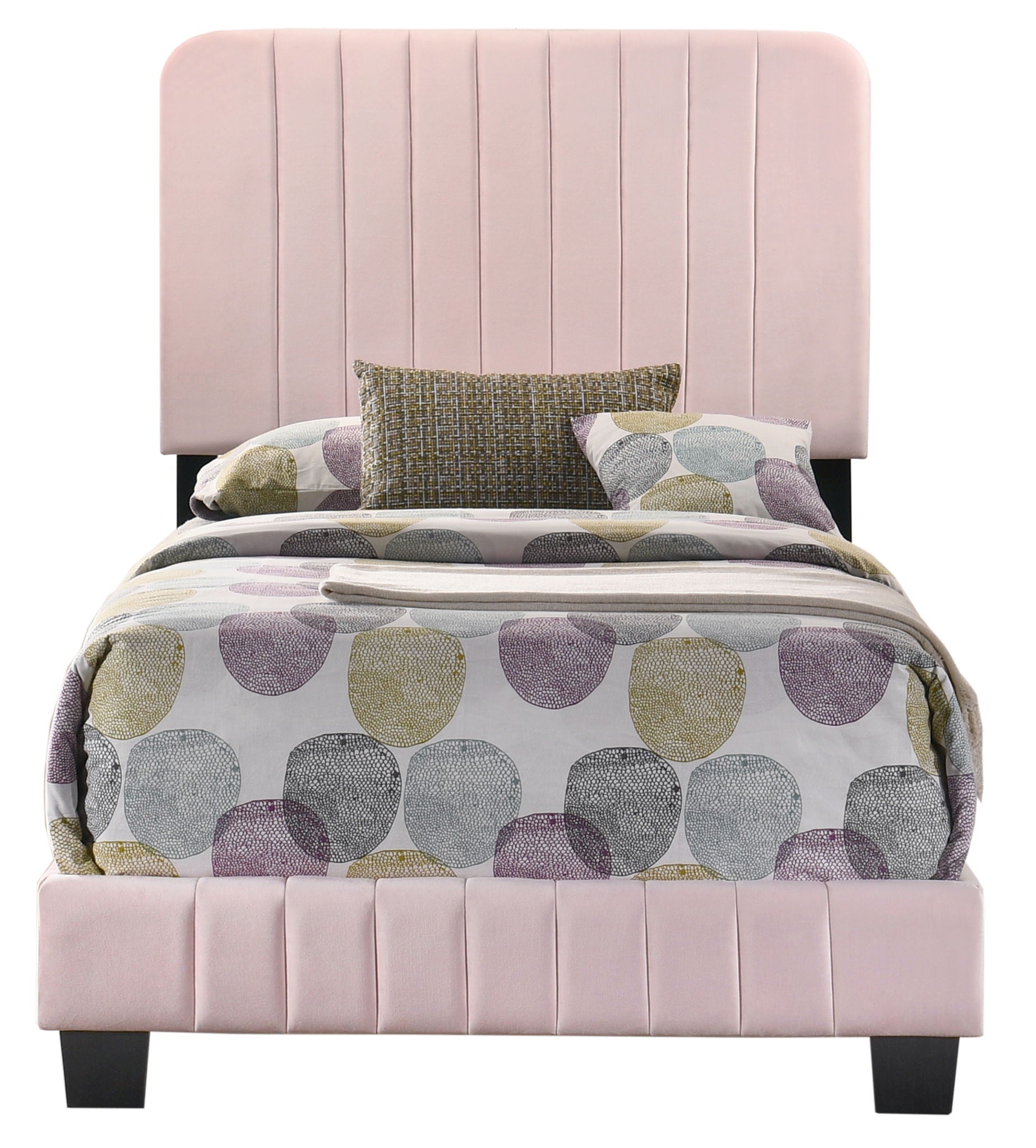 The Lodi Bed features pink upholstery and a tall, vertically paneled headboard, dressed with bedding of large gray, lavender, and olive circles plus three decorative pillows.