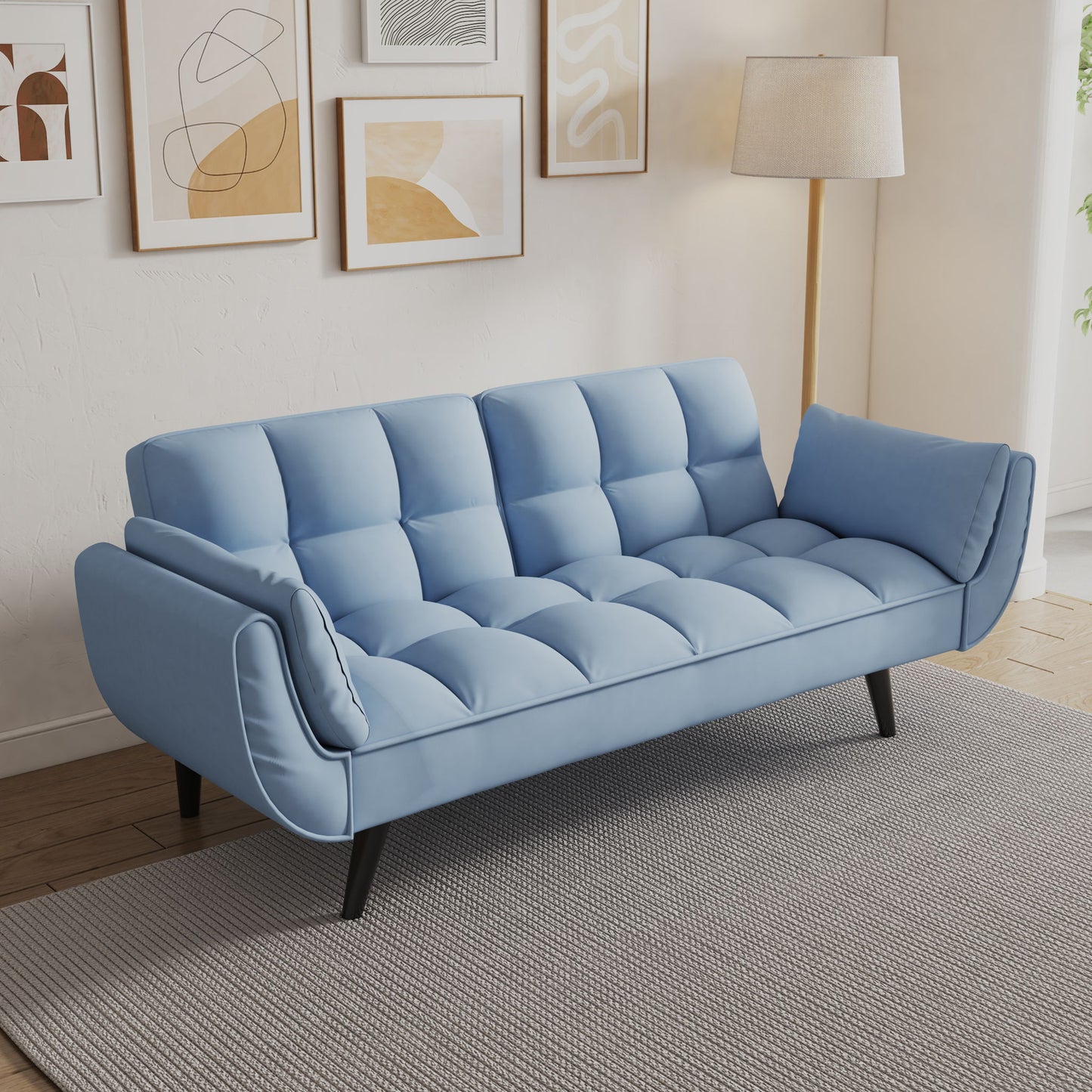 The Sofa Soft Two Armrests Throw Pillow adds comfort and style to a modern living room, featuring a light blue tufted design with black legs on a gray rug, complemented by abstract wall art, a floor lamp, neutral walls, and wood flooring.