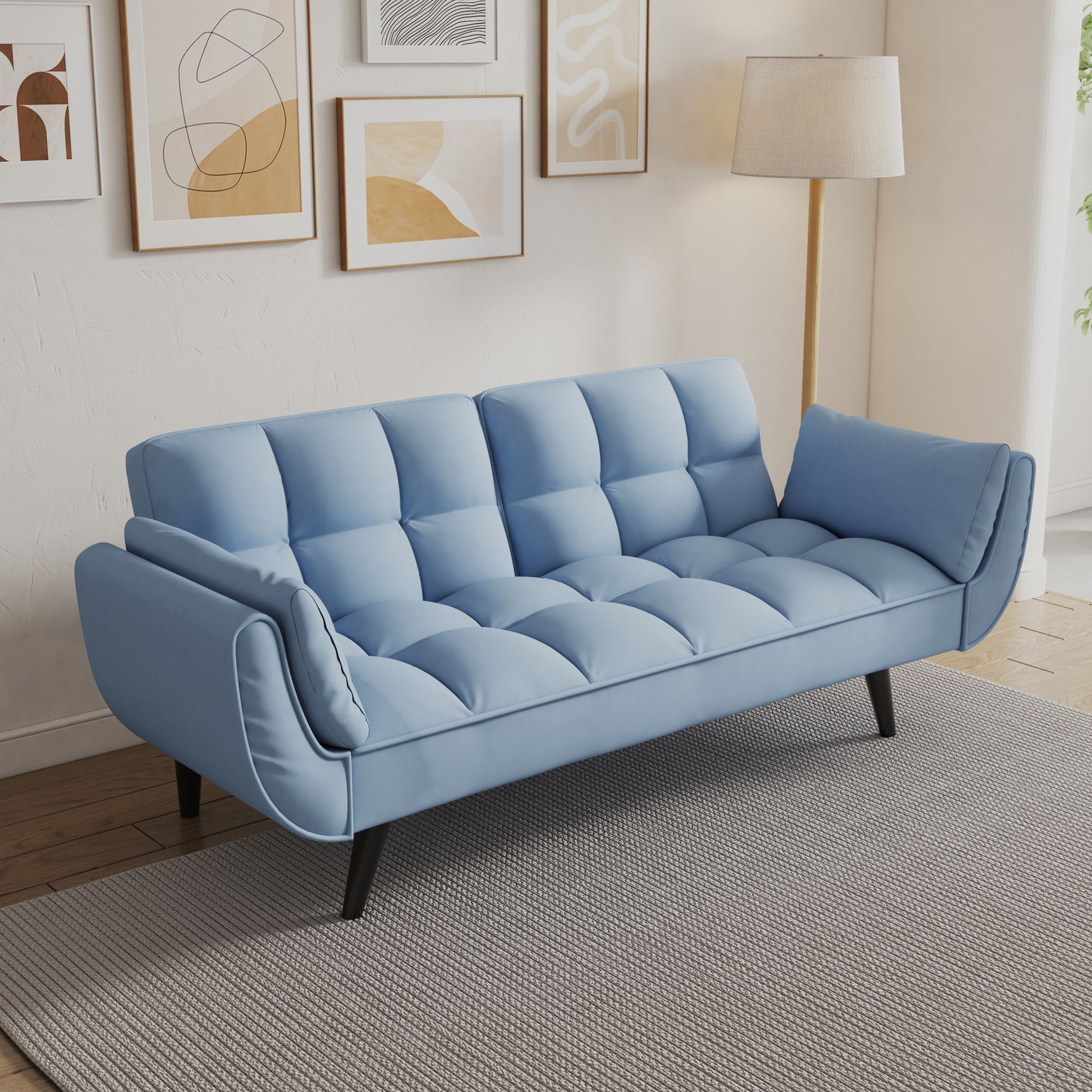 The Sofa Soft Two Armrests Throw Pillow adds comfort and style to a modern living room, featuring a light blue tufted design with black legs on a gray rug, complemented by abstract wall art, a floor lamp, neutral walls, and wood flooring.