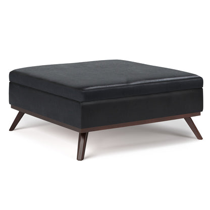 The Owen - Multifunctional Square Coffee Table Storage Ottoman features a modern black cushioned top and wooden angled legs, displayed against a white background.