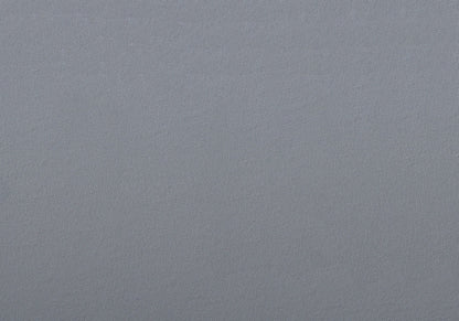 A close-up view of the smooth, subtly textured gray upholstery on the contemporary dining side chair set for your dining room.