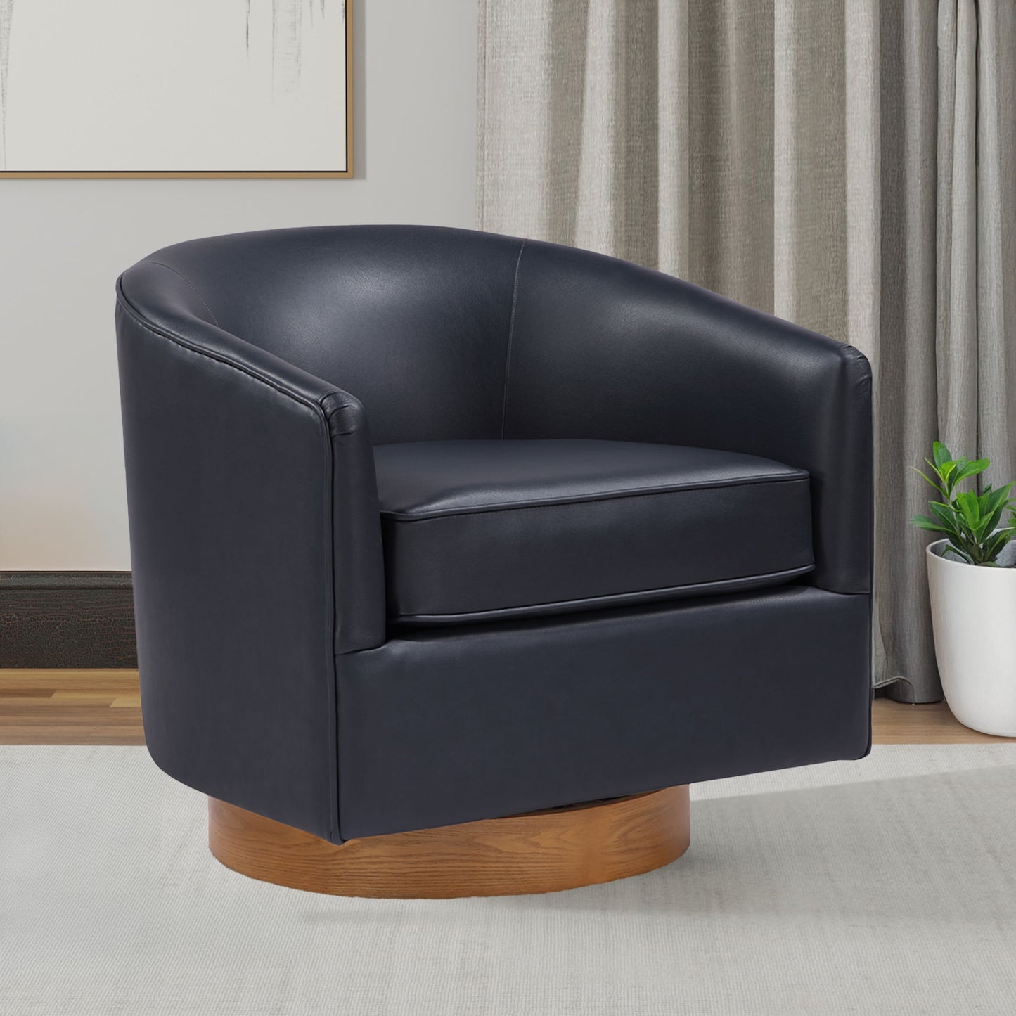 The Maisy - Barrel Swivel Chair, featuring modern black leather and a wooden base, sits on a light rug in the living room near a curtain, potted plant, and framed wall art.
