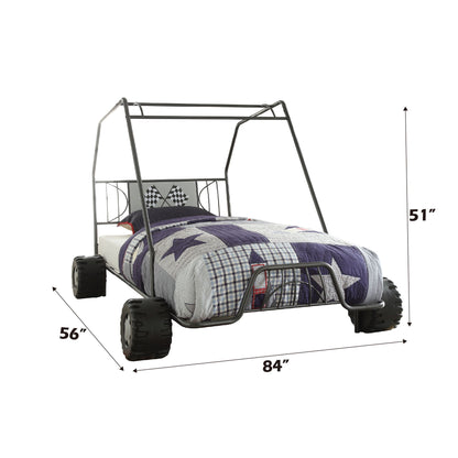 The Xander Twin Go Kart Bed in gunmetal features an off-road vehicle design with large black tires, a metal frame, and checkered flag bedding. Dimensions: 56" W x 84" L x 51" H.