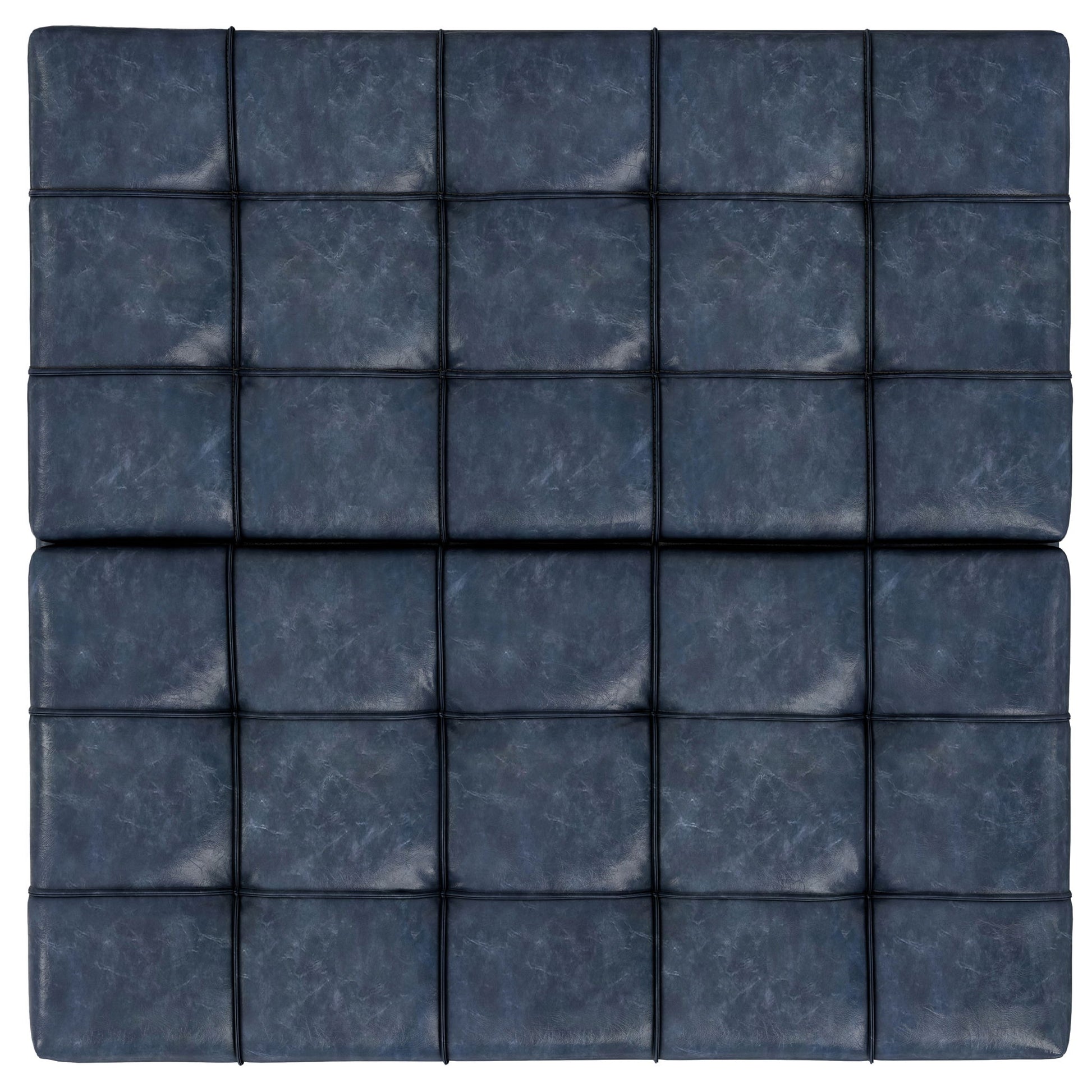 The Harrison Upholstered Coffee Table Storage Ottoman features blue padded leather with a modern grid pattern of black lines, giving it a stylish, tufted look.
