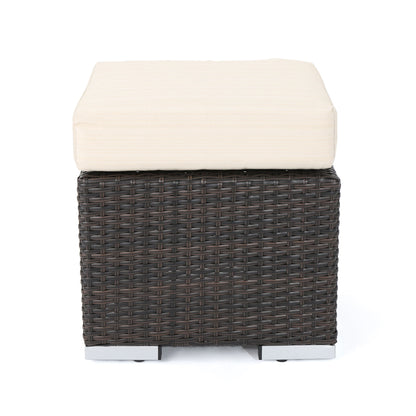 The Santa Rosa Outdoor Lounge Ottoman features a square dark brown wicker base and a thick light beige cushion, displayed against a plain white background.