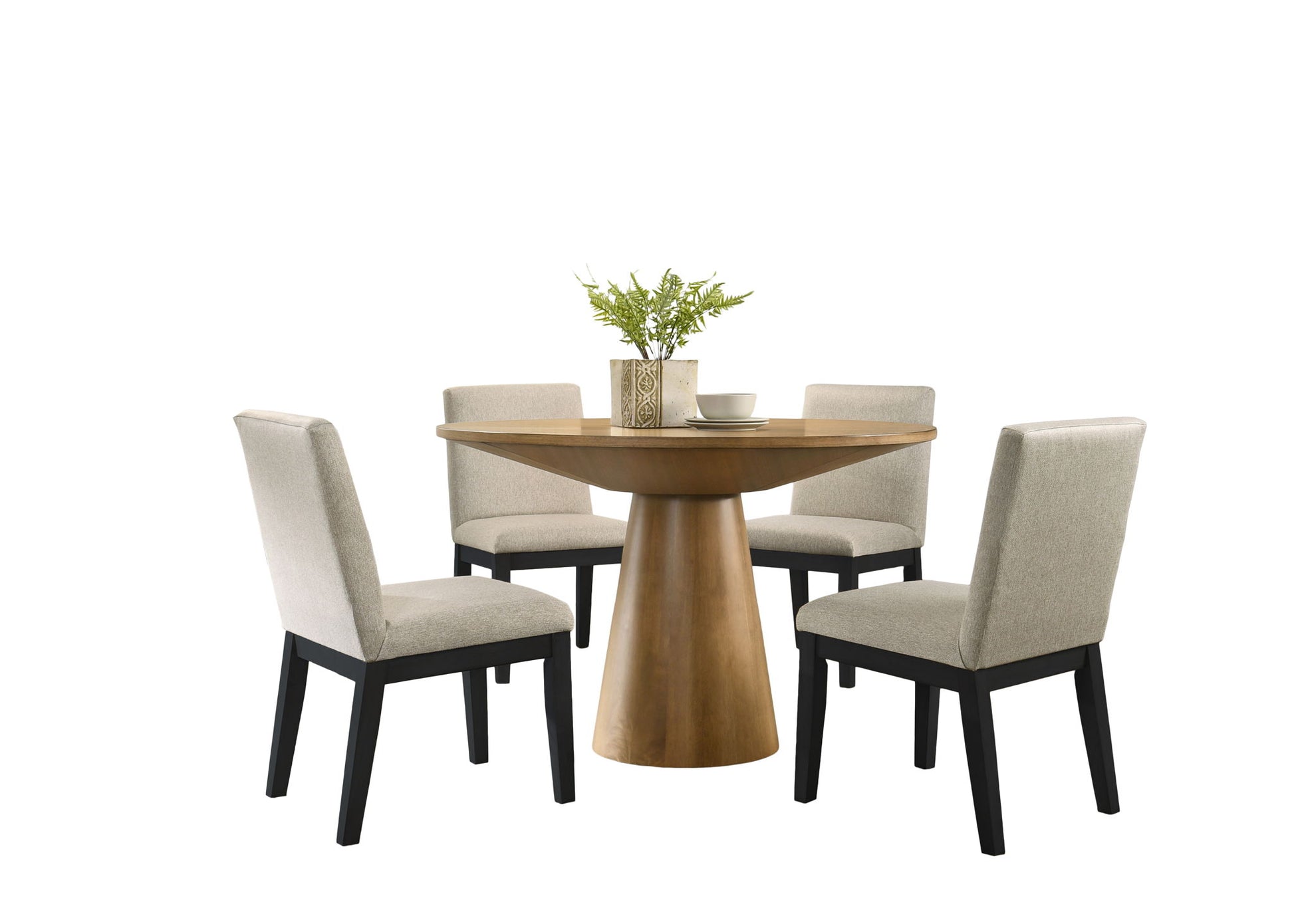 The Jasper set features a round wooden dining table with a central pedestal base, paired with four beige upholstered black finish chairs. A vase with green foliage and tableware accents the tabletop.
