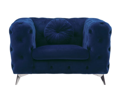 The Atronia - Chair, Elegant Design features plush deep blue velvet, tufted upholstery, a round matching cushion, wide armrests, and short angled metal legs—all set against a white background.