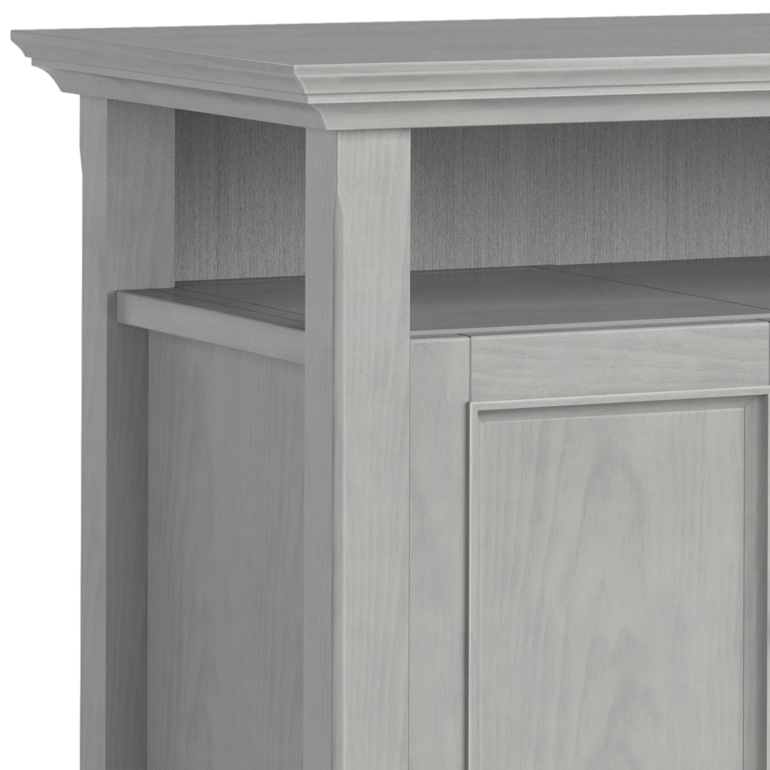 Close-up of the top corner of the Amherst - TV Media Stand, Handcrafted, showcasing its light gray finish, decorative trim, vertical paneling, and open shelf above the cabinet door.