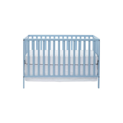 The Palmer 3-in-1 Convertible Island Crib features a light blue wooden frame with vertical slats on all sides, a white mattress, and a minimalist design, shown on a plain white background.