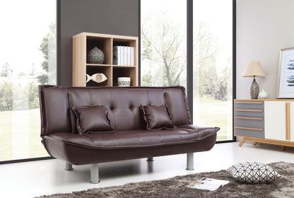A modern living room featuring the Lionel - Sofa Bed in dark brown leather, two matching cushions, a shaggy gray rug, a patterned pillow, wooden shelf, sideboard, lamp, and large windows overlooking trees.