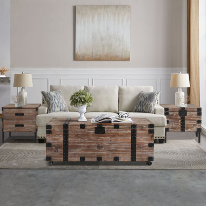 A living room with a beige sofa, two patterned cushions, the Trunk Table And Side Table With Large Storage (Set of 3) in Antique Gray, a potted plant, and a neutral abstract painting on the wall.