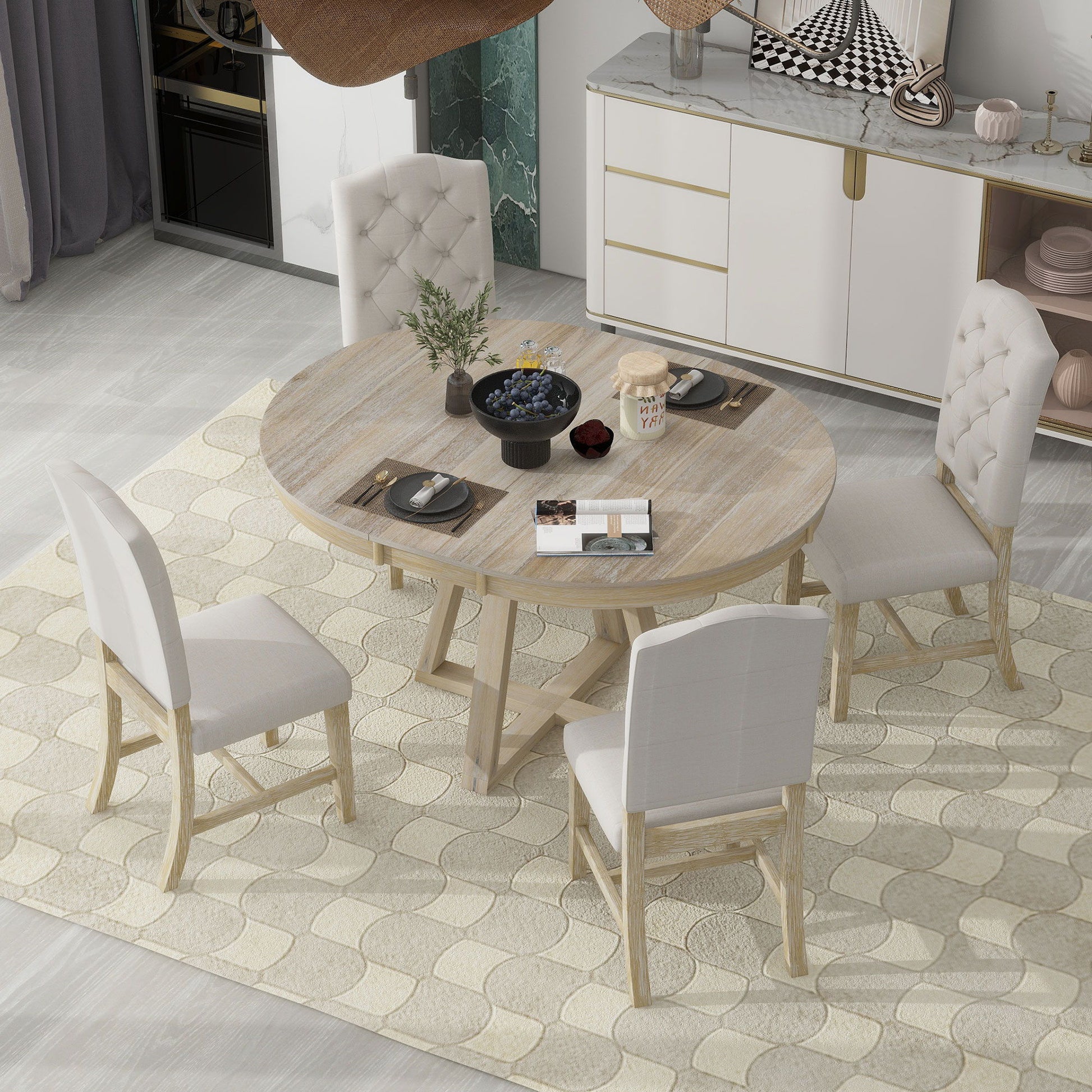 The Retro Functional Dining Set features a round table with leaf and four white upholstered chairs, shown on a patterned beige rug in a modern dining room with a sideboard and decorative accents.