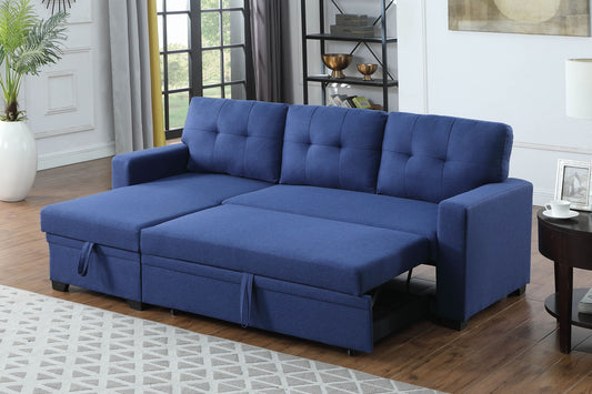 A modern living room features the Upholstered Pull Out Sectional Sofa With Chaise extended for sleeping, wood floors, a light rug, decor shelves, a side table, and large windows with gray curtains.