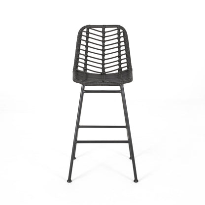 The Sawtelle Outdoor Wicker Barstools (Set of 2) feature a modern black design with woven rattan-style backrests and seats, slim metal legs, and a footrest, shown against a plain white background.