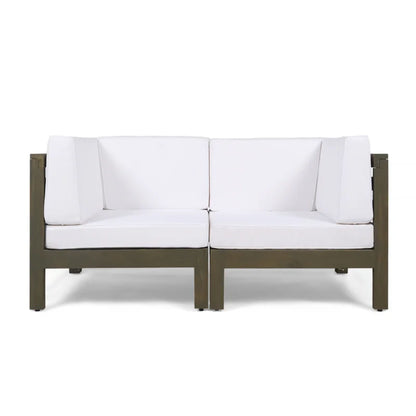 The Oana 2 Piece Loveseat Set features a modern design with a dark wooden frame and water-resistant white cushioned seats and backrests, displayed against a plain white background.