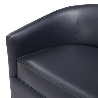 Close-up view of the Maisy - Barrel Swivel Chair, featuring a modern design in dark blue leather with a curved back and a smooth, cushioned seat.