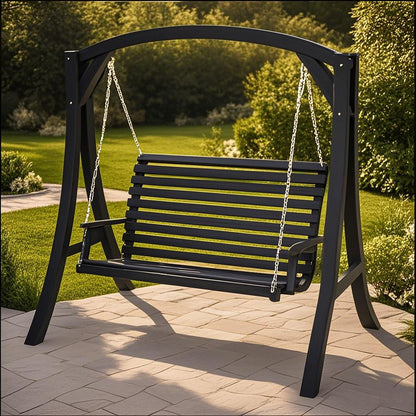 The San Juan Outdoor Swinging Loveseat With Support, made of black wood and metal chains, hangs from a sturdy frame on a stone patio, with green grass and trees in the background.