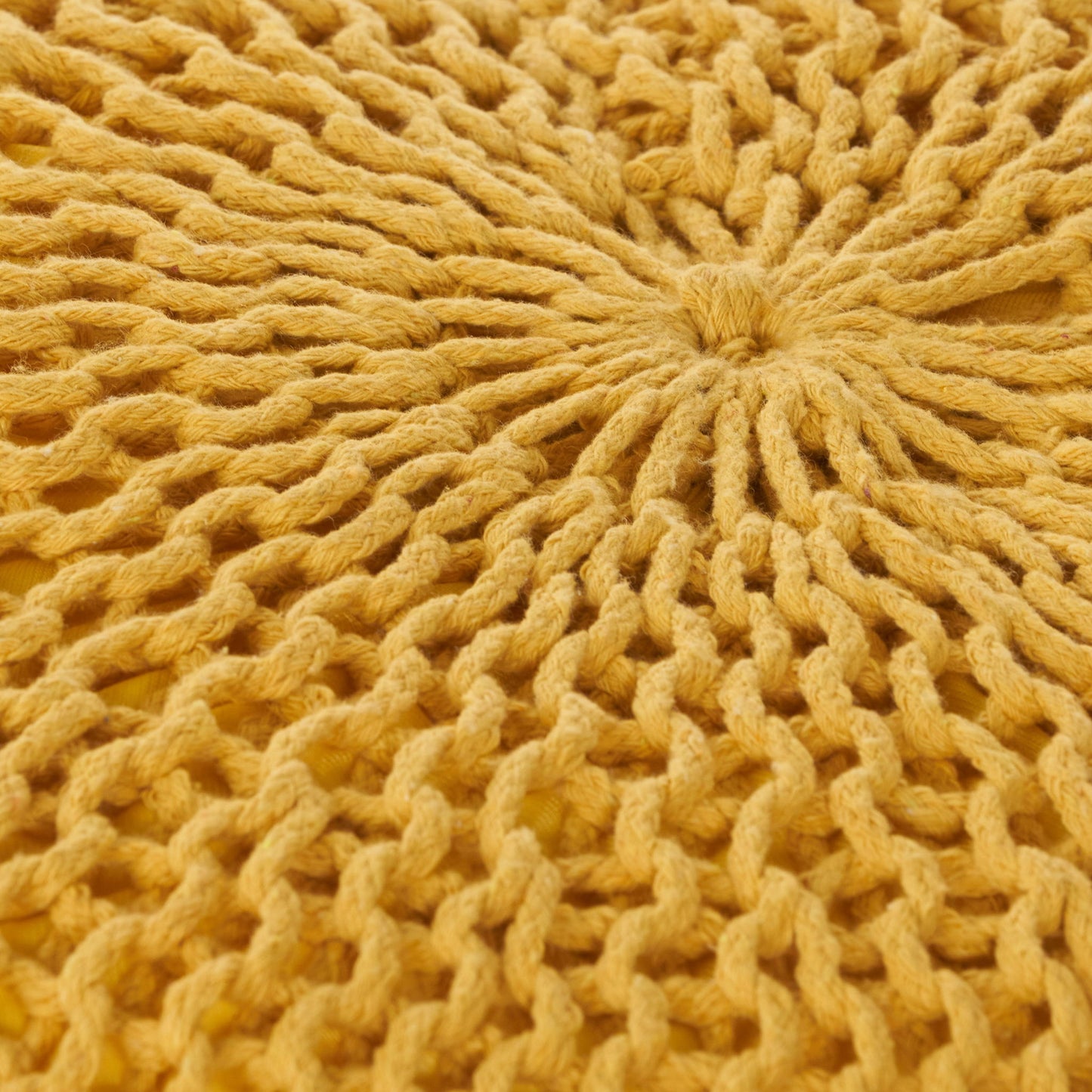 Close-up of the Bordeaux Knitted Cotton Round Pouf, a yellow hand-knitted ottoman and floor cushion featuring a circular radial pattern with thick, textured yarn.