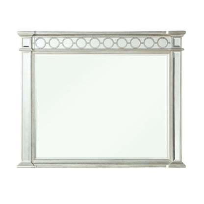 The Varian - Mirrored Designed Mirror in silver features a rectangular frame with decorative circular accents along the top edge, displayed against a white background.