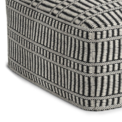 Close-up of the corner of the Safford Square Woven Outdoor/Indoor Pouf in black and white, featuring a textured geometric pattern with stripes and rectangles.