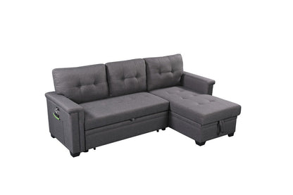 The Nathan Reversible Sleeper Sectional Sofa features a dark gray design with a storage chaise, tufted cushions, USB charging ports, and a left armrest pocket, shown against a white background.