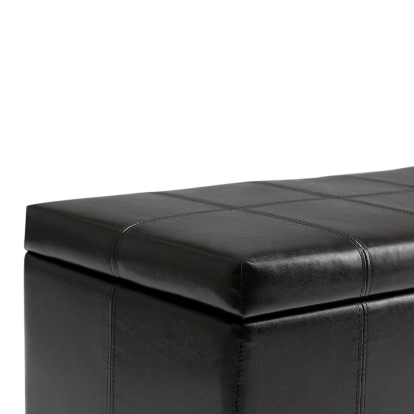 A close-up of the Dover - Upholstered Storage Ottoman Bench in black leather, highlighting its visible stitching detail on the cushioned top and side.