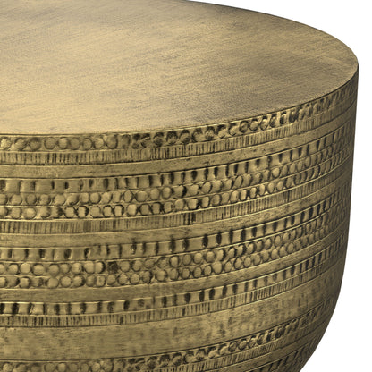 Close-up of the Johnsen - Handcrafted Metal Coffee Table, showcasing its round metallic gold surface with textured, engraved patterns of horizontal rows of small dots and lines.