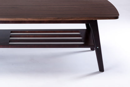 A close-up of the Bahamas Coffee Table features a dark wood finish, angled legs, and a slatted lower shelf, all set against a white background.