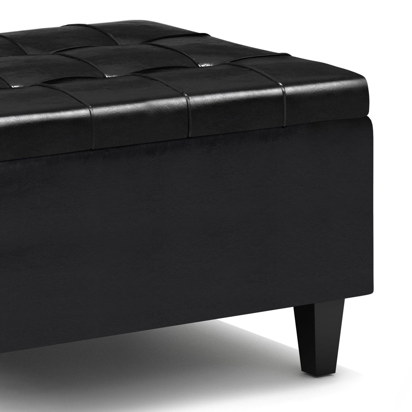 Close-up of the Harrison - Upholstered Coffee Table Storage Ottoman featuring a black rectangular design, tufted checkered leather top, and short angled legs, set against a white background.