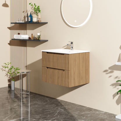 Modern bathroom with a 24" Walnut wall-mount floating vanity cabinet, white sink, round backlit mirror, wall shelves for toiletries and plants, gray marble flooring, and minimalist decor in neutral tones.
