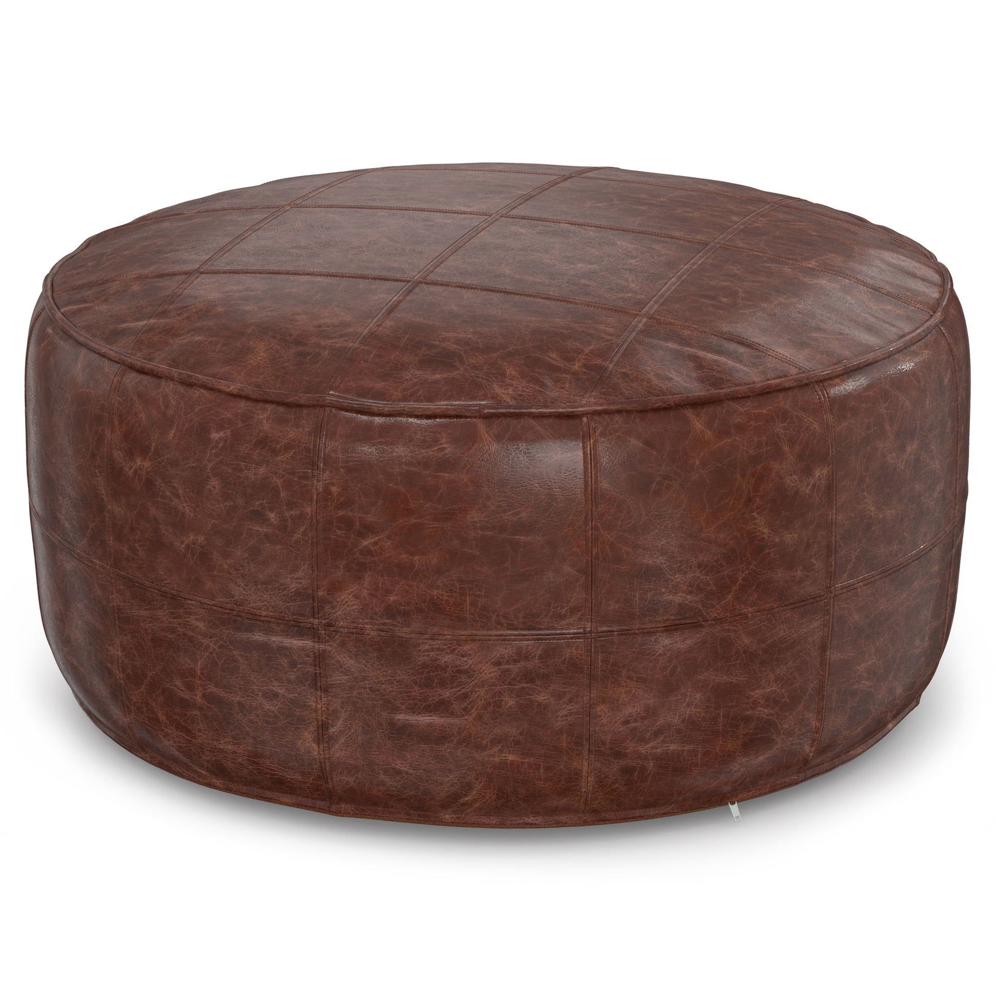The Connor - Handcrafted Round Pouf features brown leather with visible grid stitching and a slightly distressed texture for a rustic look.
