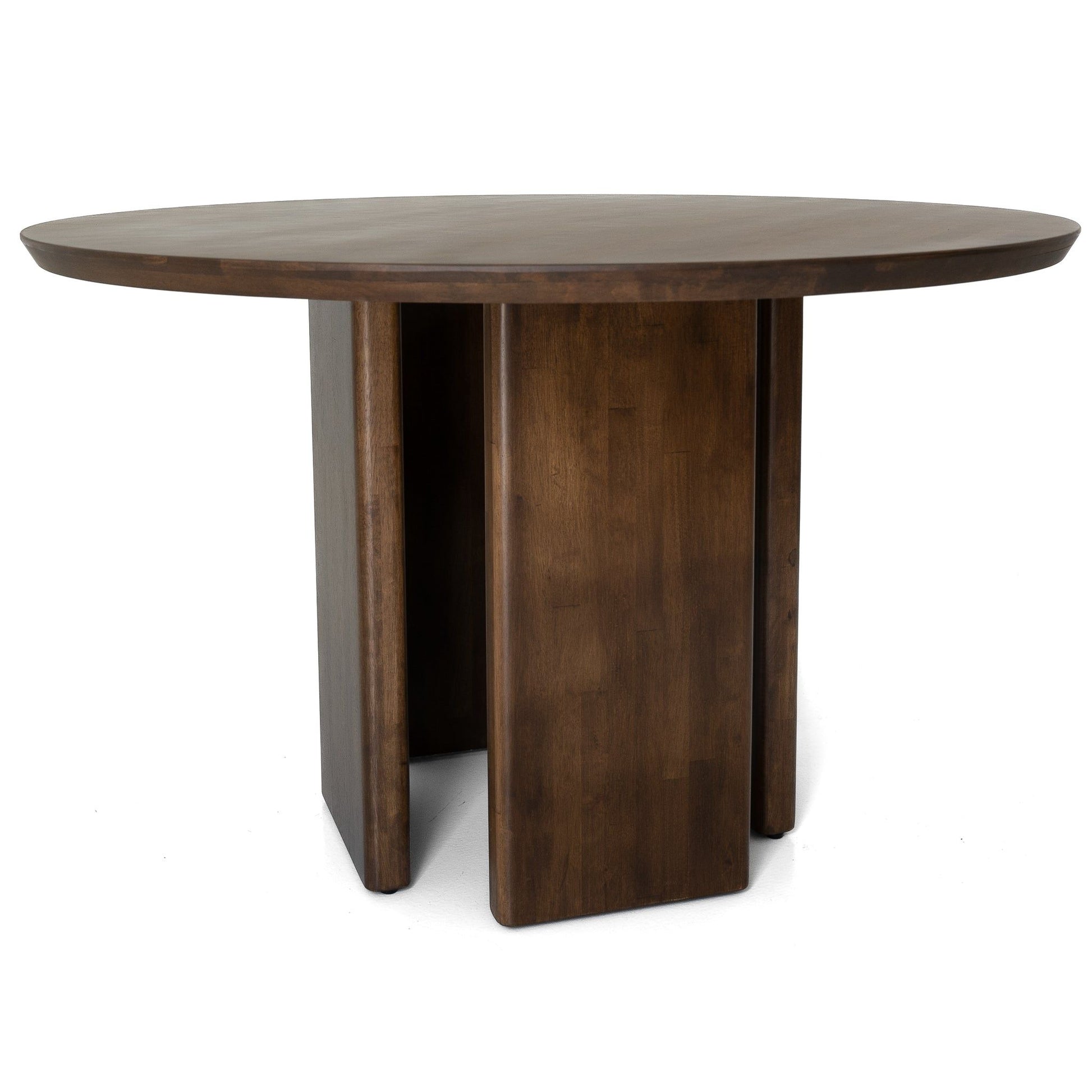 The Alden Round Dining Table in Walnut features a smooth, dark brown wooden surface and a sturdy base with four wide vertical panels intersecting at the center.
