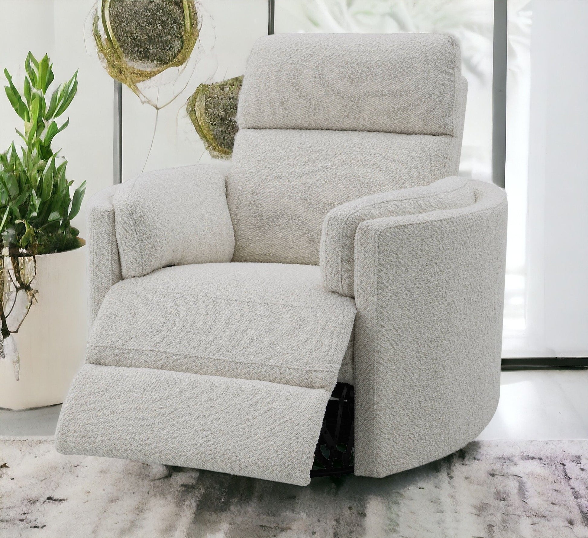 The Sagen Chenille Glider Recliner With Swivel, in light beige textured fabric, is extended in a modern living room with a green potted plant and large windows streaming natural light in the background.