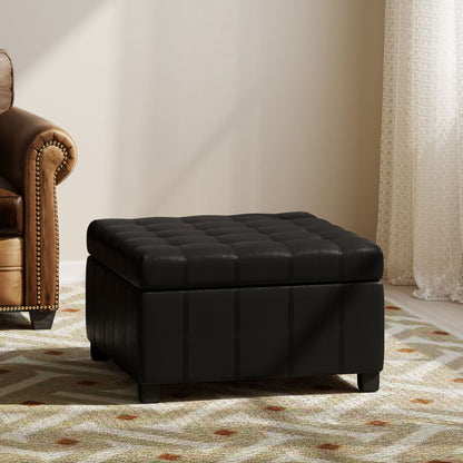 A Storage Ottoman For Living Room sits on a patterned area rug beside a brown leather armchair in a sunlit room with light walls and sheer curtains.