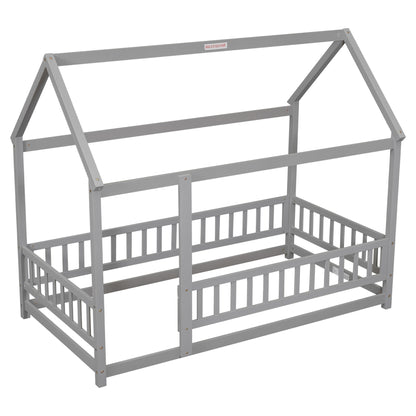 The Floor Wooden Bed With House Roof Frame and Fence Guardrails is a gray, house-shaped wooden bed for children with slatted sides and an open, minimalist design. Mattress and bedding are not included.