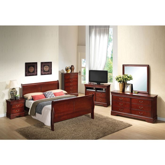 A spacious bedroom with light walls, wood floors, a beige rug, and large window features classic dark wood furniture: a Panel Sleigh Bed, nightstand, dresser with mirror, chest of drawers, and a TV stand.