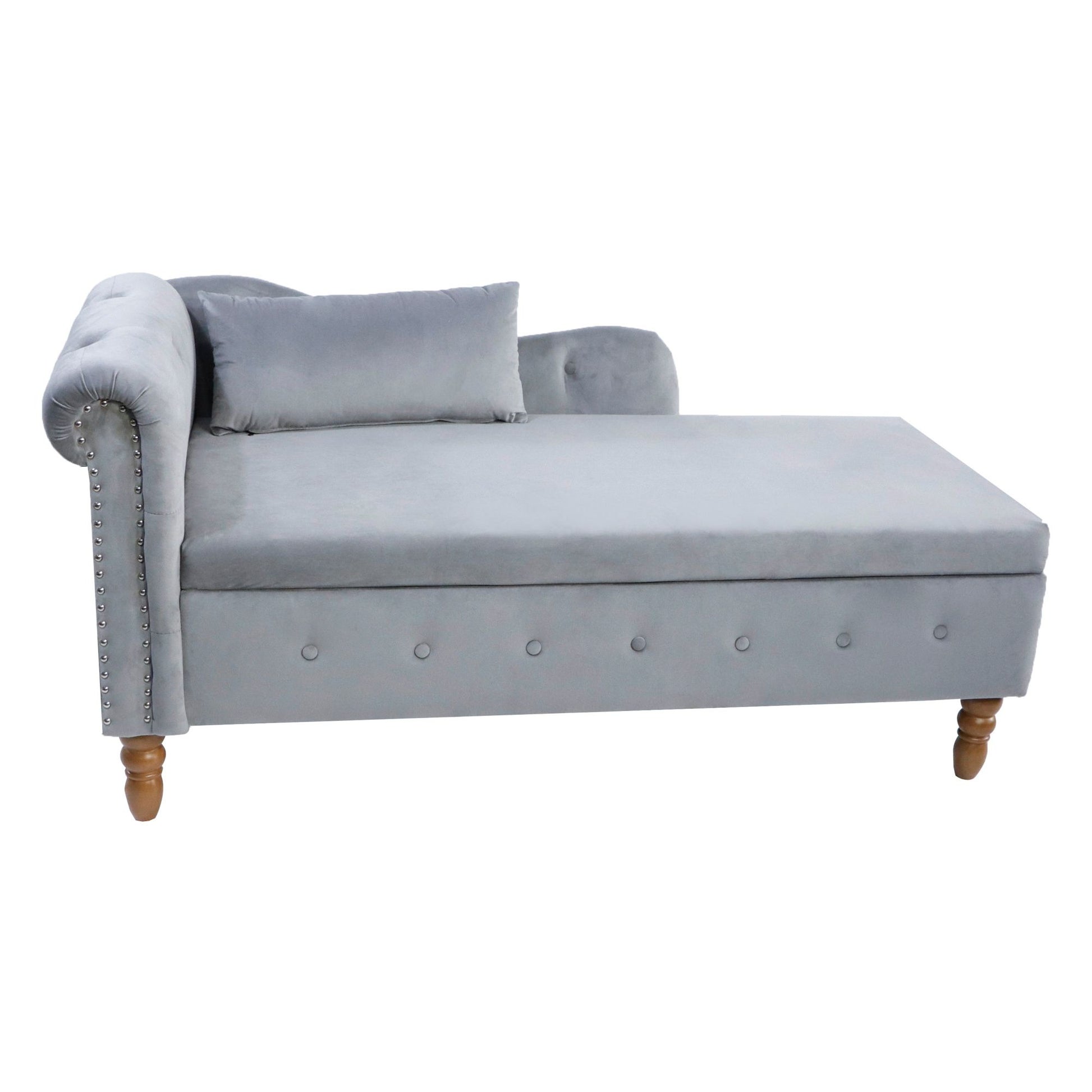 The Chaise Lounge Indoor is a modern velvet lounge chair with storage, a left rolled armrest, wooden legs, button tufted front, nailhead trim, and comes with a matching pillow—perfect for your bedroom, living room, or office.