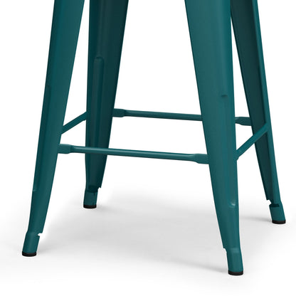Close-up of the lower legs and footrests of the Rayne - Multifunctional Metal Stool in teal, shown on a white background. This stool features black protective caps on the feet and boasts a simple, industrial design.