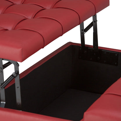 A close-up of the Harrison Upholstered Coffee Table Storage Ottoman shows its red tufted cushioned lid open, revealing a spacious black storage compartment inside, supported by sturdy metal hinges.