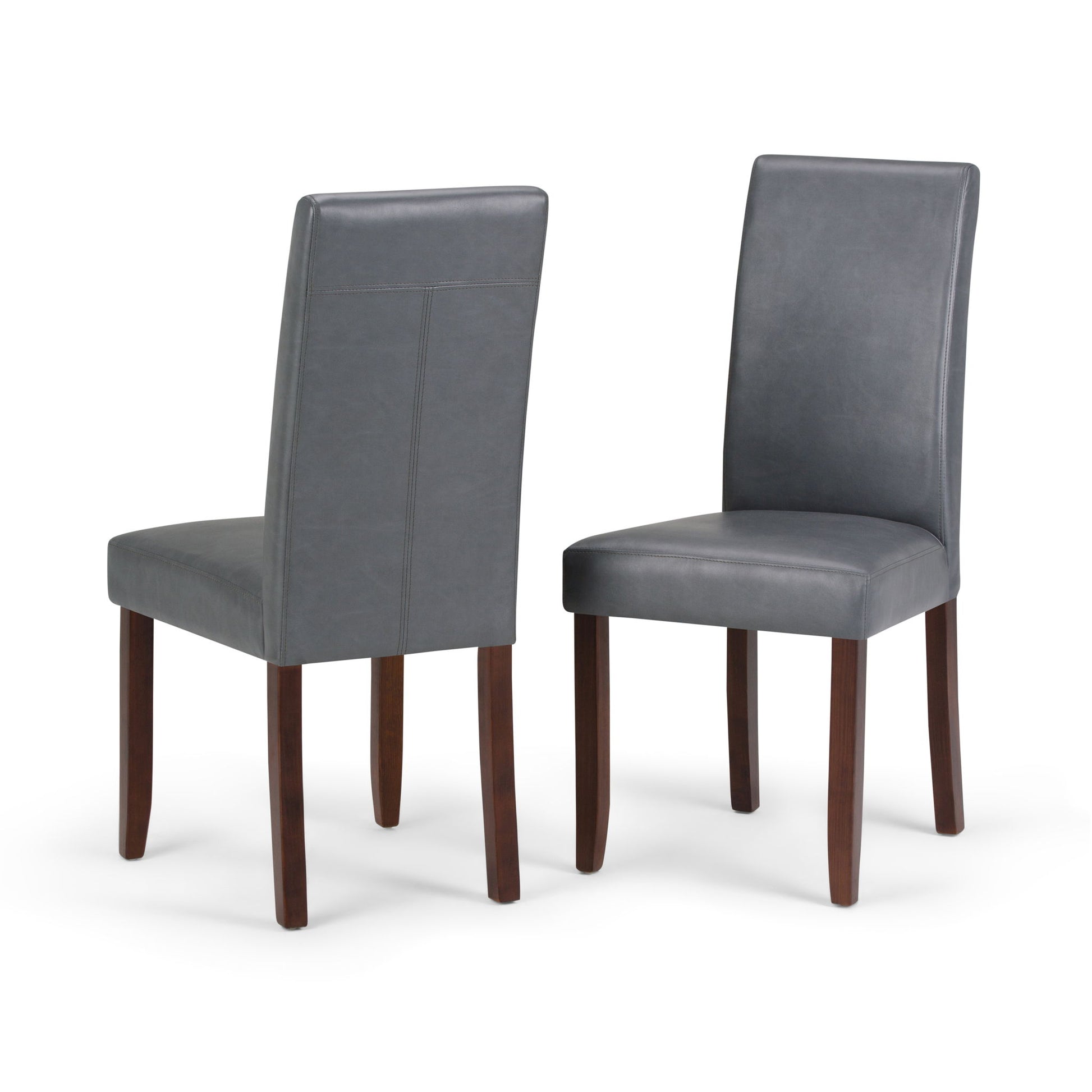 The Acadian - Upholstered Parson Dining Chair (Set of 2) features two gray high-back chairs with dark wooden legs, one facing forward and one backward, displayed against a white background.