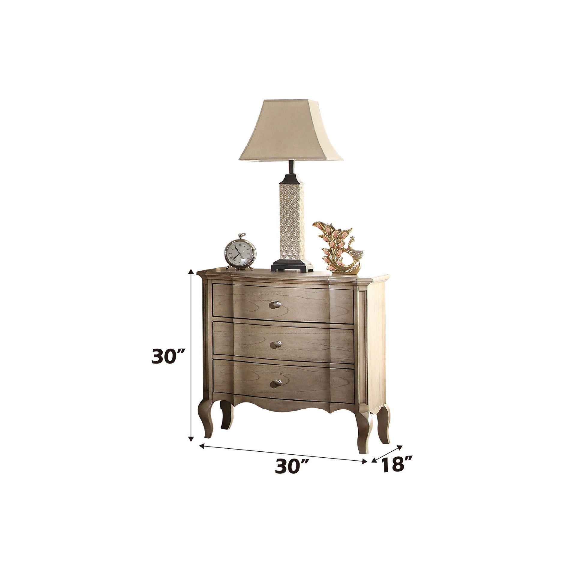 The Chelmsford Nightstand, featuring classic and modern design, has three drawers with silver knobs, curved legs, and measures 30"W x 18"D x 30"H. Its spacious top can hold a lamp, clock, and decorative items.