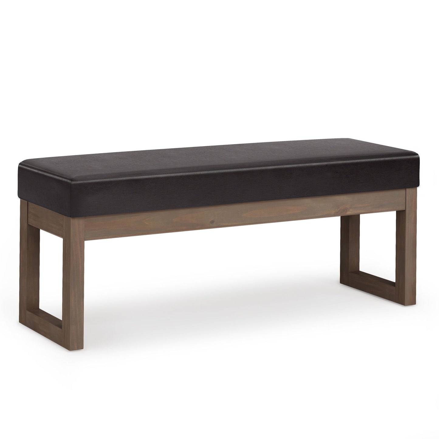 The Milltown Upholstered Ottoman Bench features a dark cushioned seat and a sturdy, rectangular wooden frame in a natural finish with open square legs at each end.